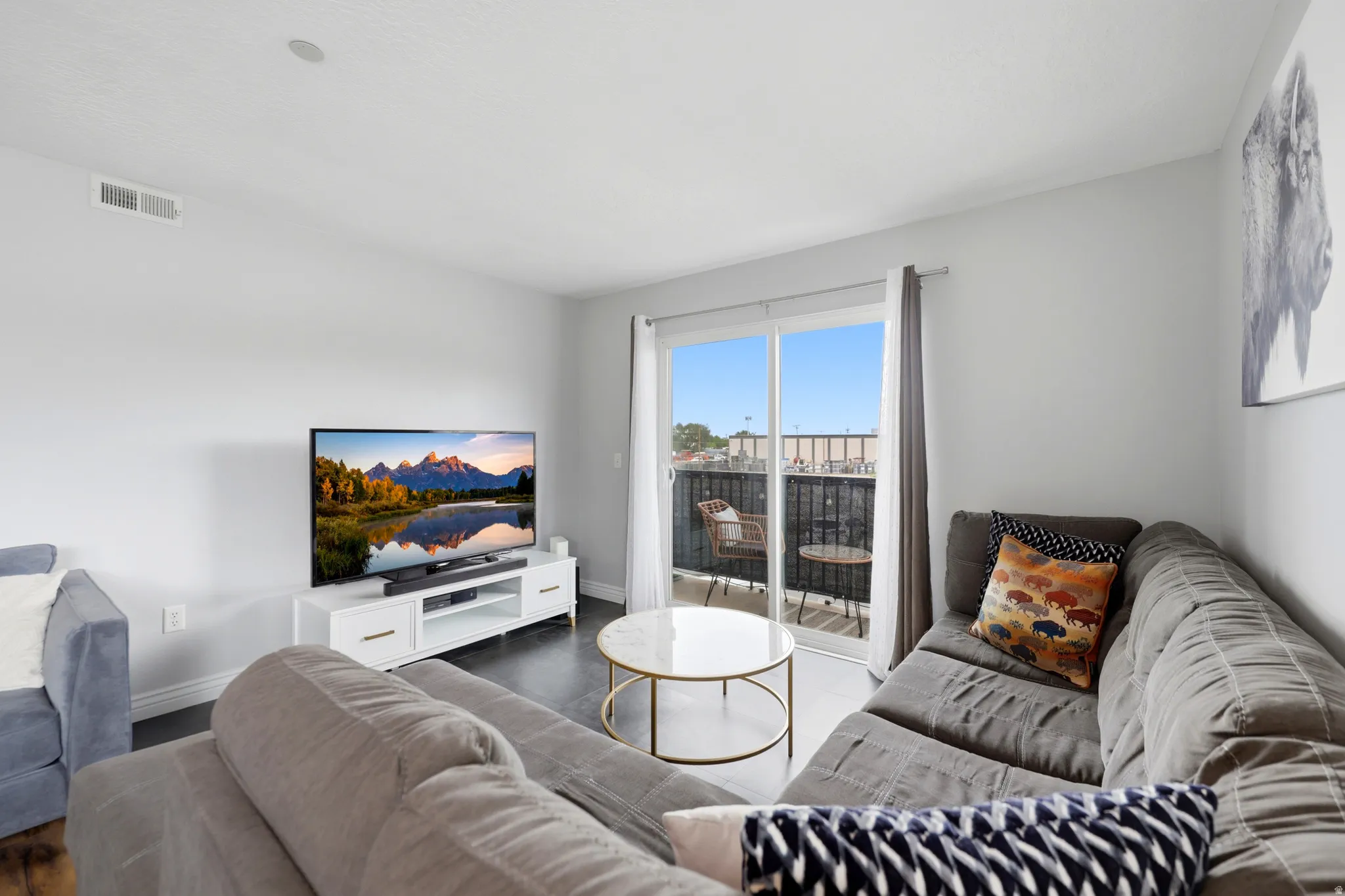 Living area featuring dark flooring and light-toned walls