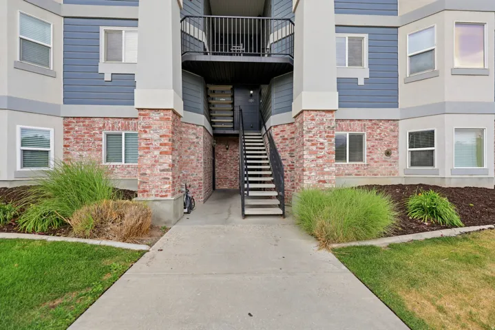 Multi-level building exterior featuring brick and siding accents