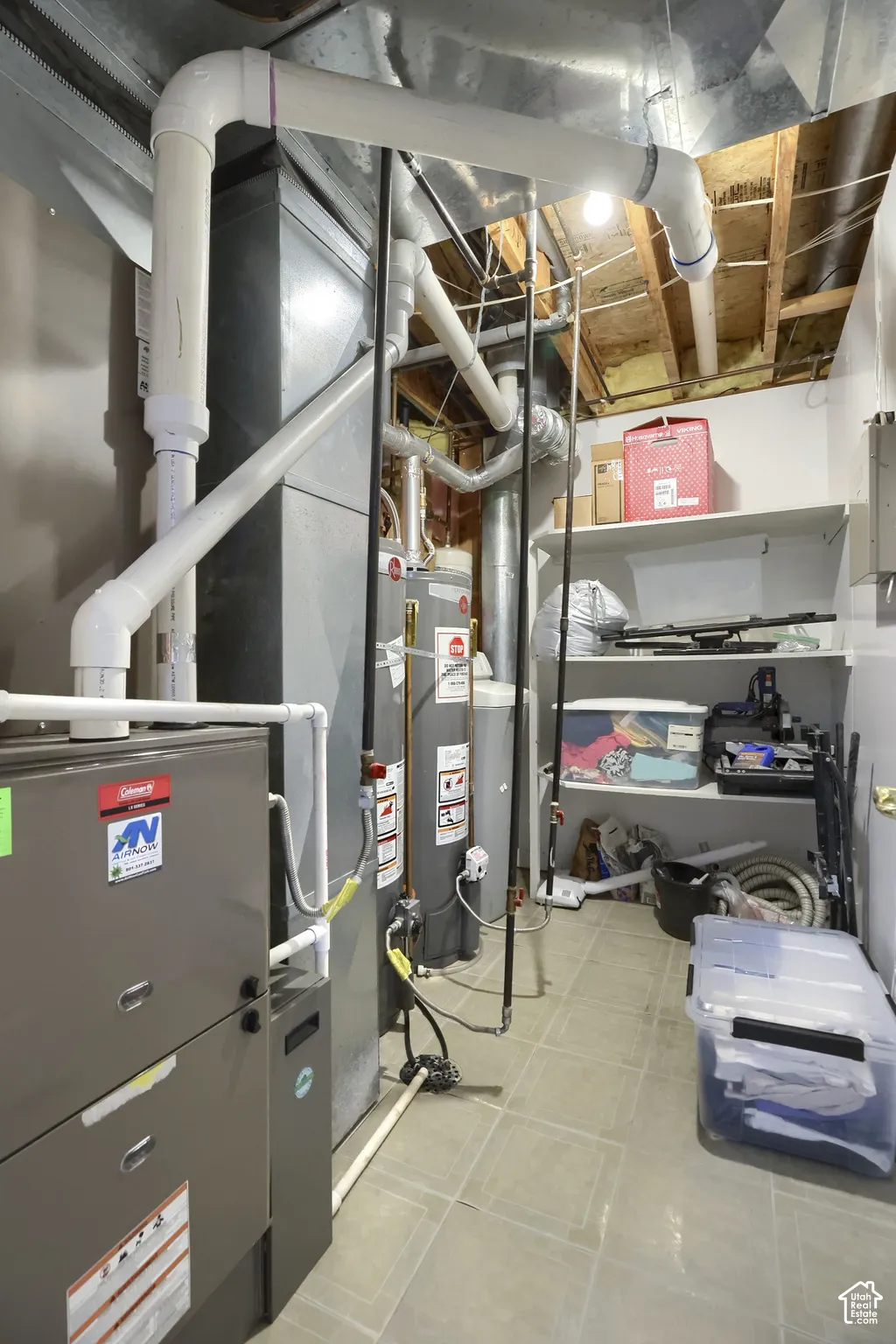 Dedicated utility room featuring mechanical systems, water heater, tile flooring, and integrated shelving