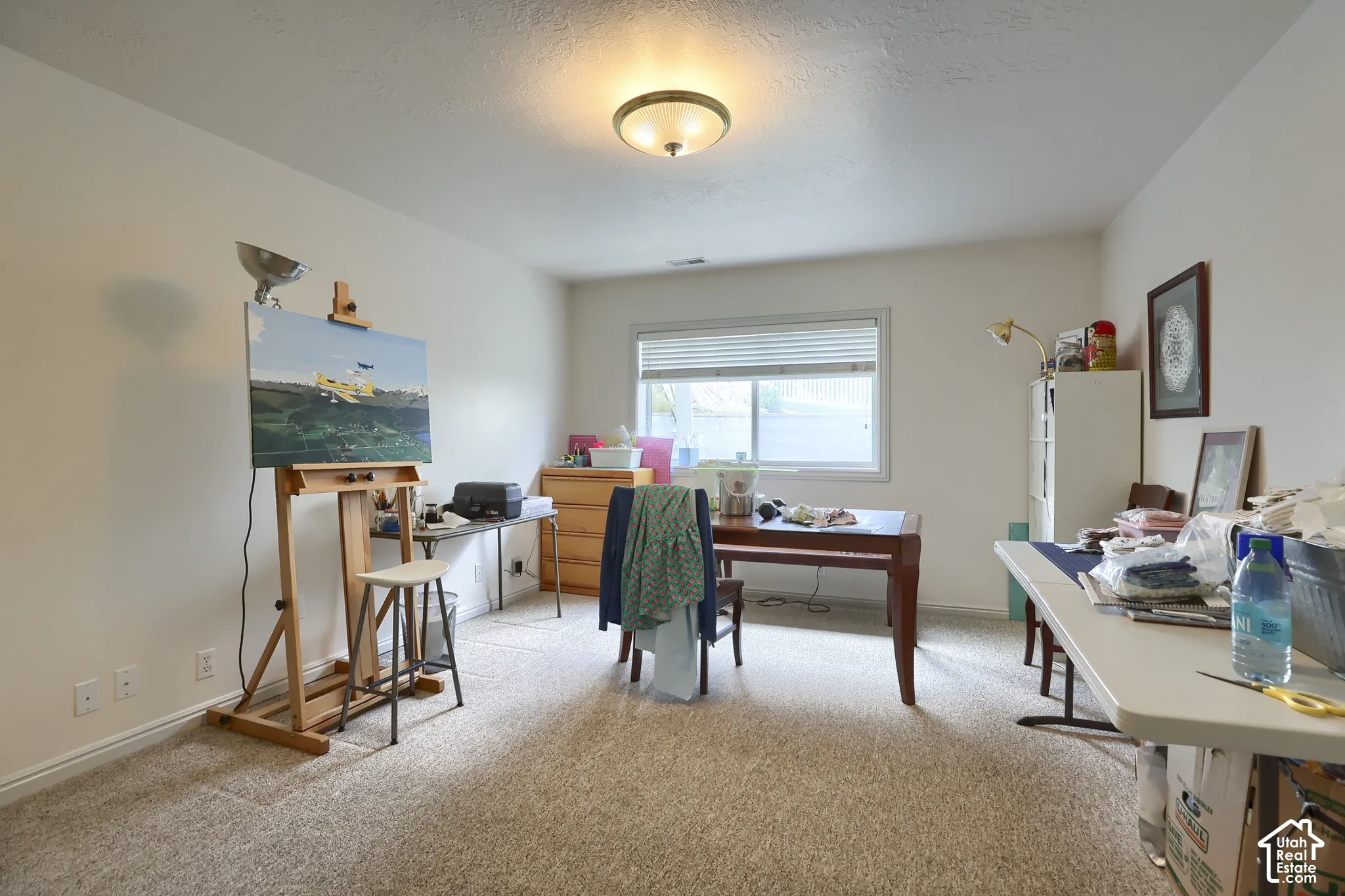 Spacious room featuring neutral carpet flooring and white painted walls