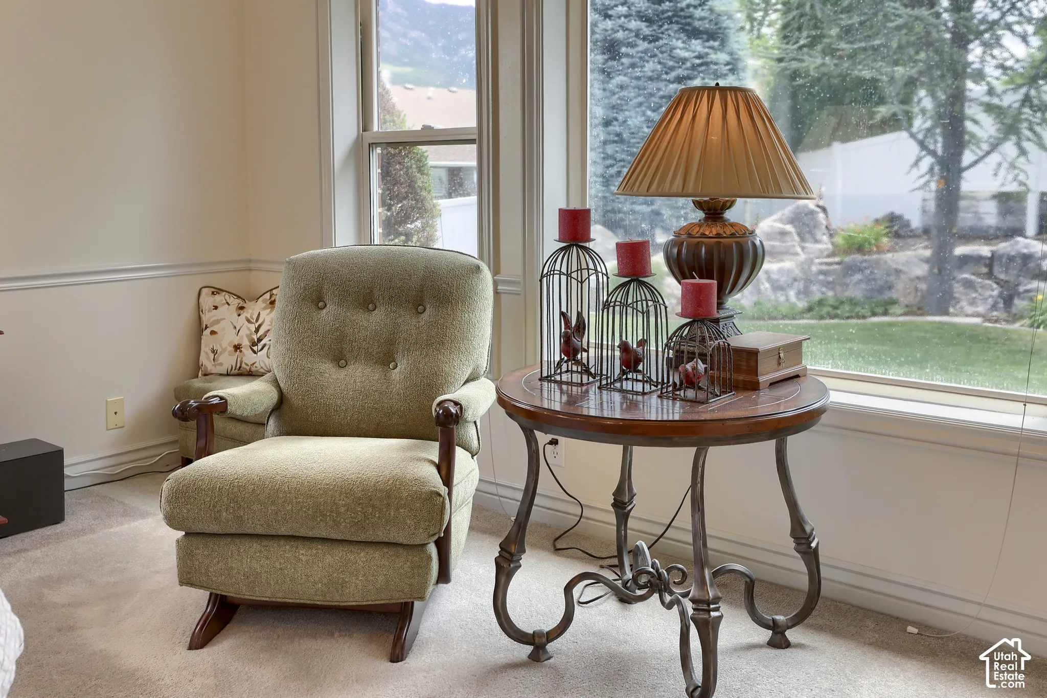 Bright interior space featuring large windows, neutral-toned walls with chair rail molding, and soft carpeting