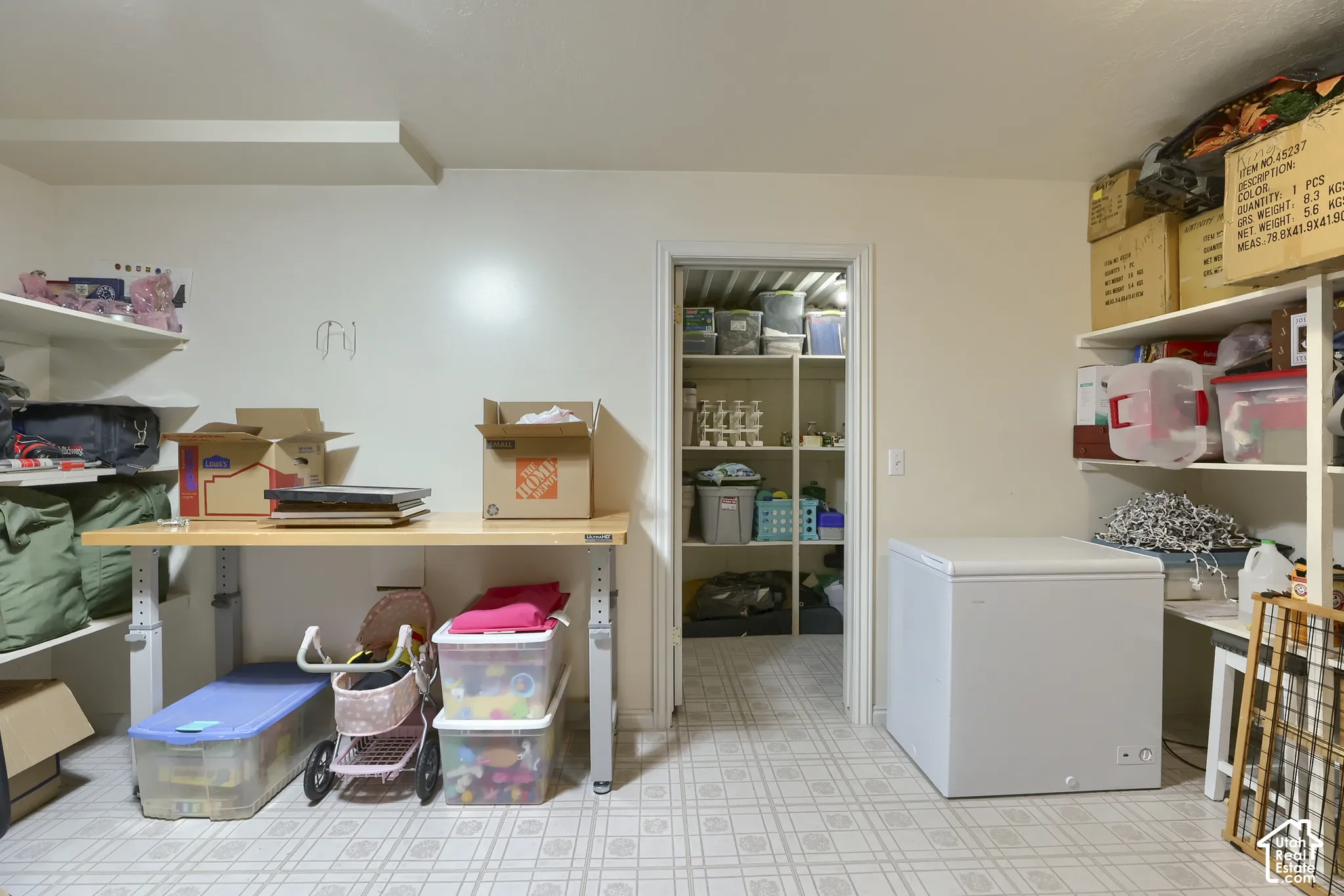 Utility room featuring white walls and patterned flooring