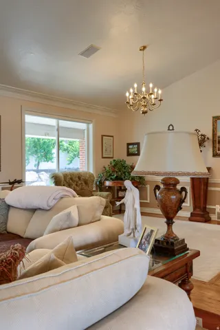 Vaulted ceiling featuring a brass chandelier and recessed lighting