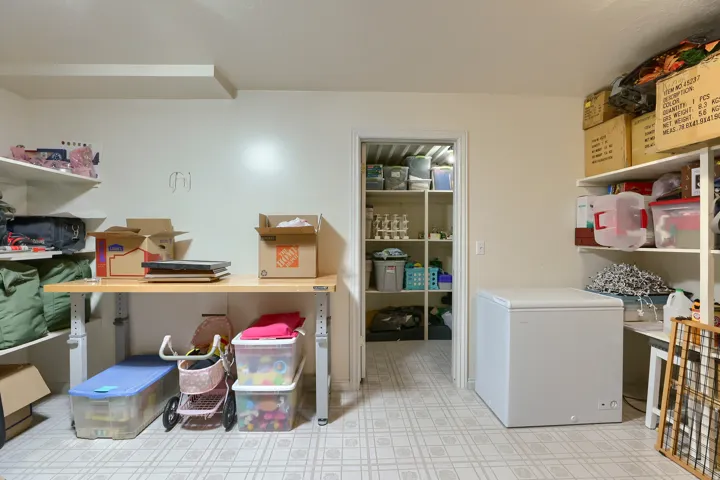 Utility room featuring white walls and patterned flooring
