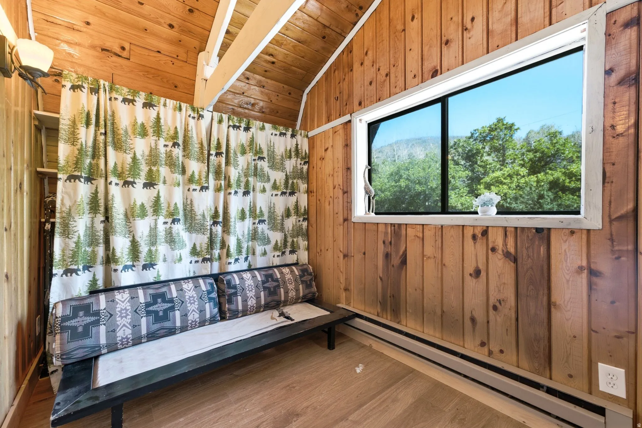 Wood-paneled room with vaulted wood-plank ceiling