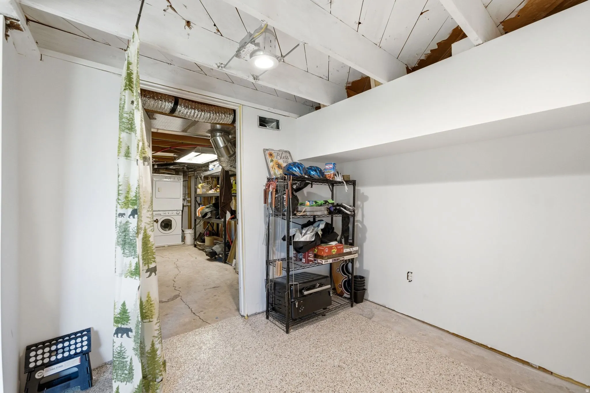 Lower-level space featuring a light-colored, textured floor