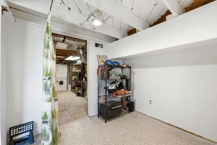 Lower-level space featuring a light-colored, textured floor