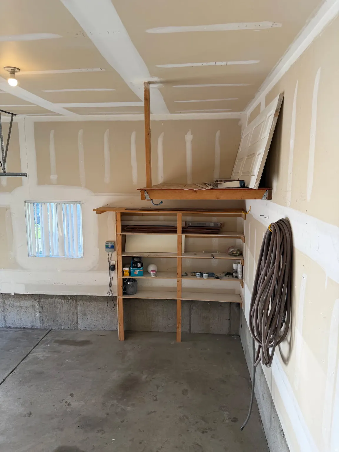 Garage interior with concrete flooring and exposed concrete foundation