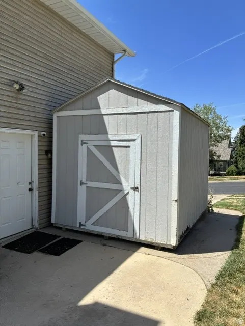 Gray utility shed with white trim and a gabled roof