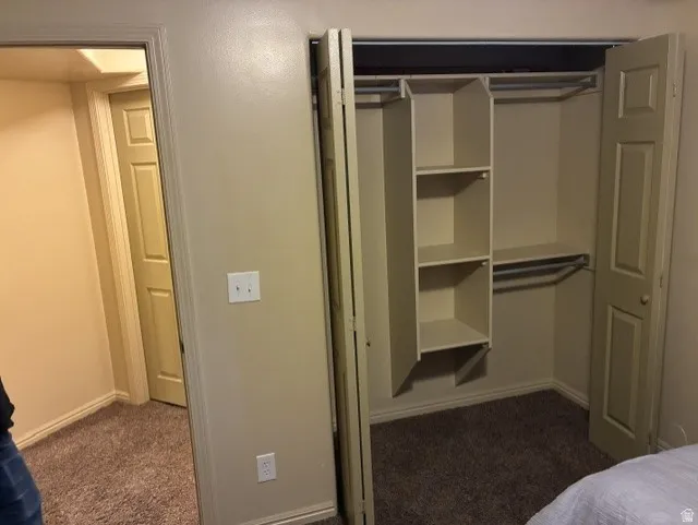 Closet featuring bifold doors, built-in shelving, and hanging rods