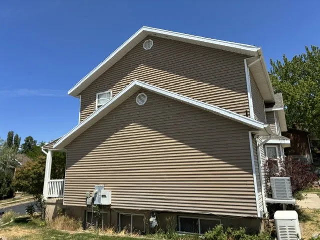 Multi-level exterior with horizontal siding and white trim