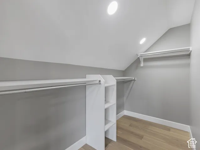 Home 1/2 -- 1046 S Lincoln Street -- Walk-in closet featuring built-in shelving, white baseboards, wood-finish flooring, and recessed ceiling lighting