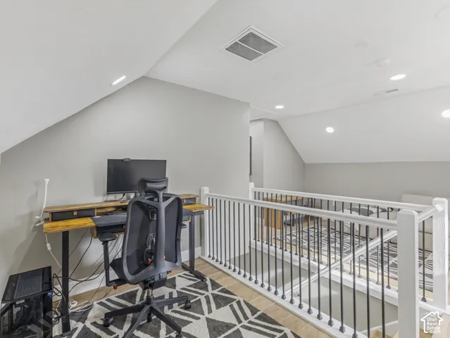Home 1/2 -- 1046 S Lincoln Street -- Loft area featuring vaulted ceilings, recessed lighting, wood-finish flooring, and a white railing with black balusters