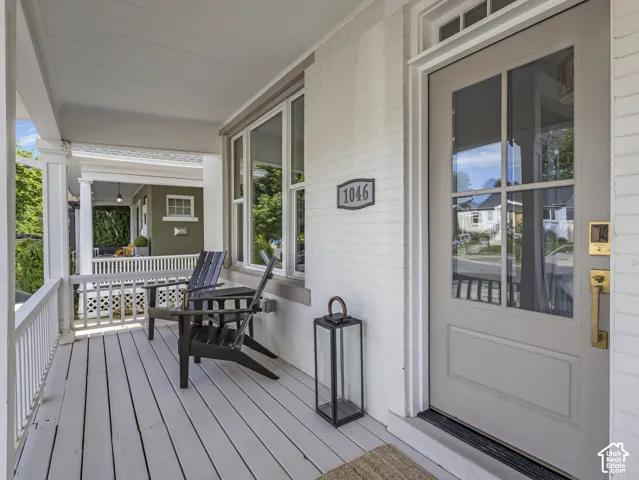 Home 1/2 -- 1046 S Lincoln Street -- Inviting front porch featuring painted wood flooring, white railings, and a contrasting brick facade