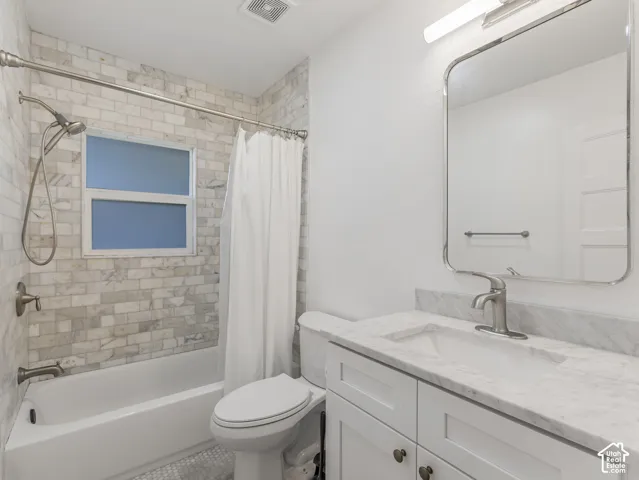 Home 2/2 - 938 E Herbert Avenue -- Bathroom featuring a white bathtub, subway tile shower surround, and a vanity with a stone countertop
