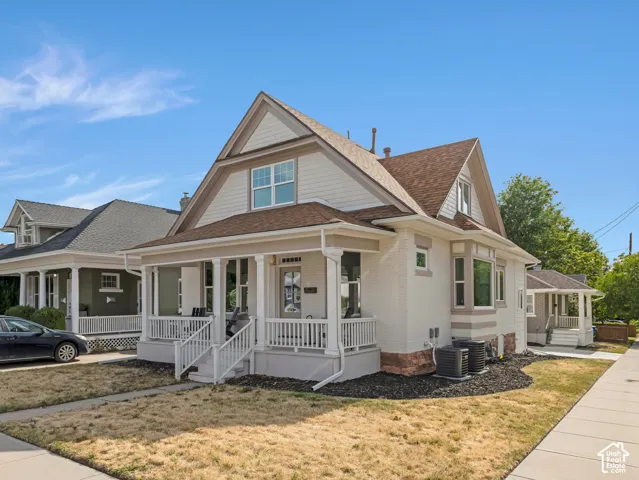 Home 1/2 -- 1046 S Lincoln Street -- Craftsman-style home featuring a covered front porch, light-colored brick exterior, and a prominent gable roof