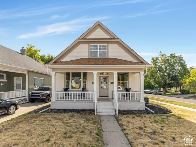 Home 1/2 -- 1046 S Lincoln Street -- Craftsman-style facade with a covered front porch featuring white railings and columns