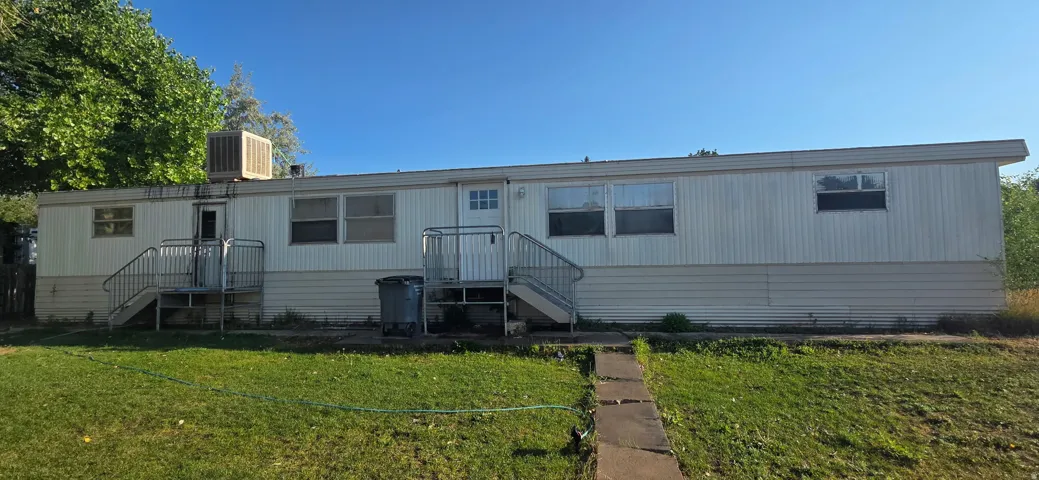 Single-story exterior featuring a white siding finish