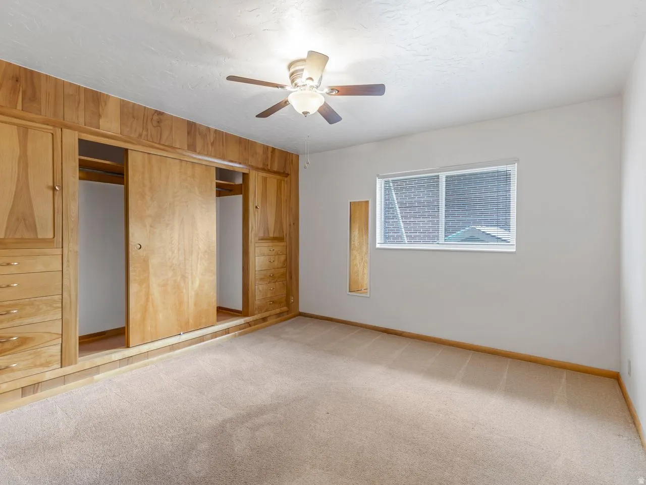 Built-in wood-finish cabinetry featuring multiple drawers and sliding doors