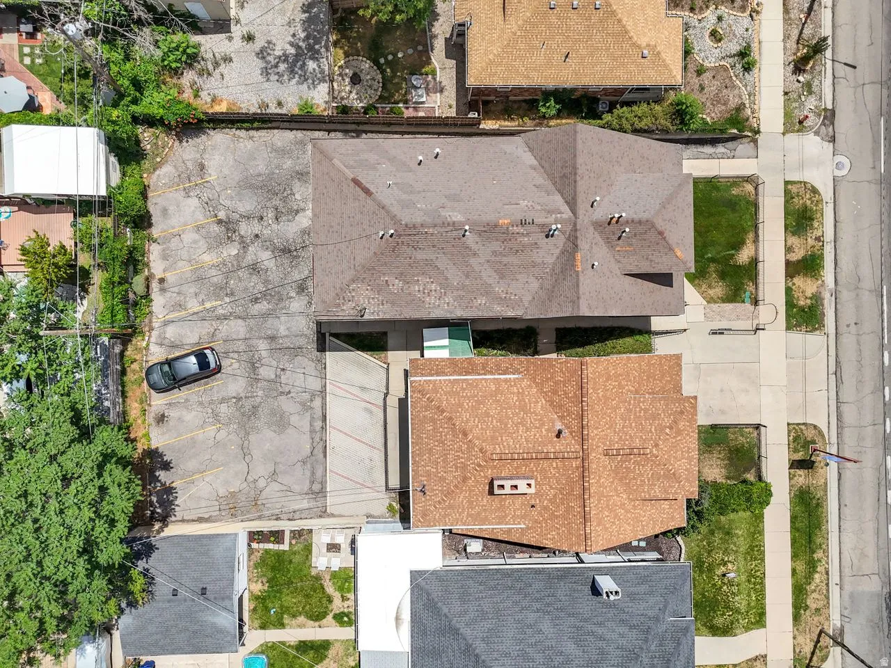 Two-story residential structure with a brown shingled roof