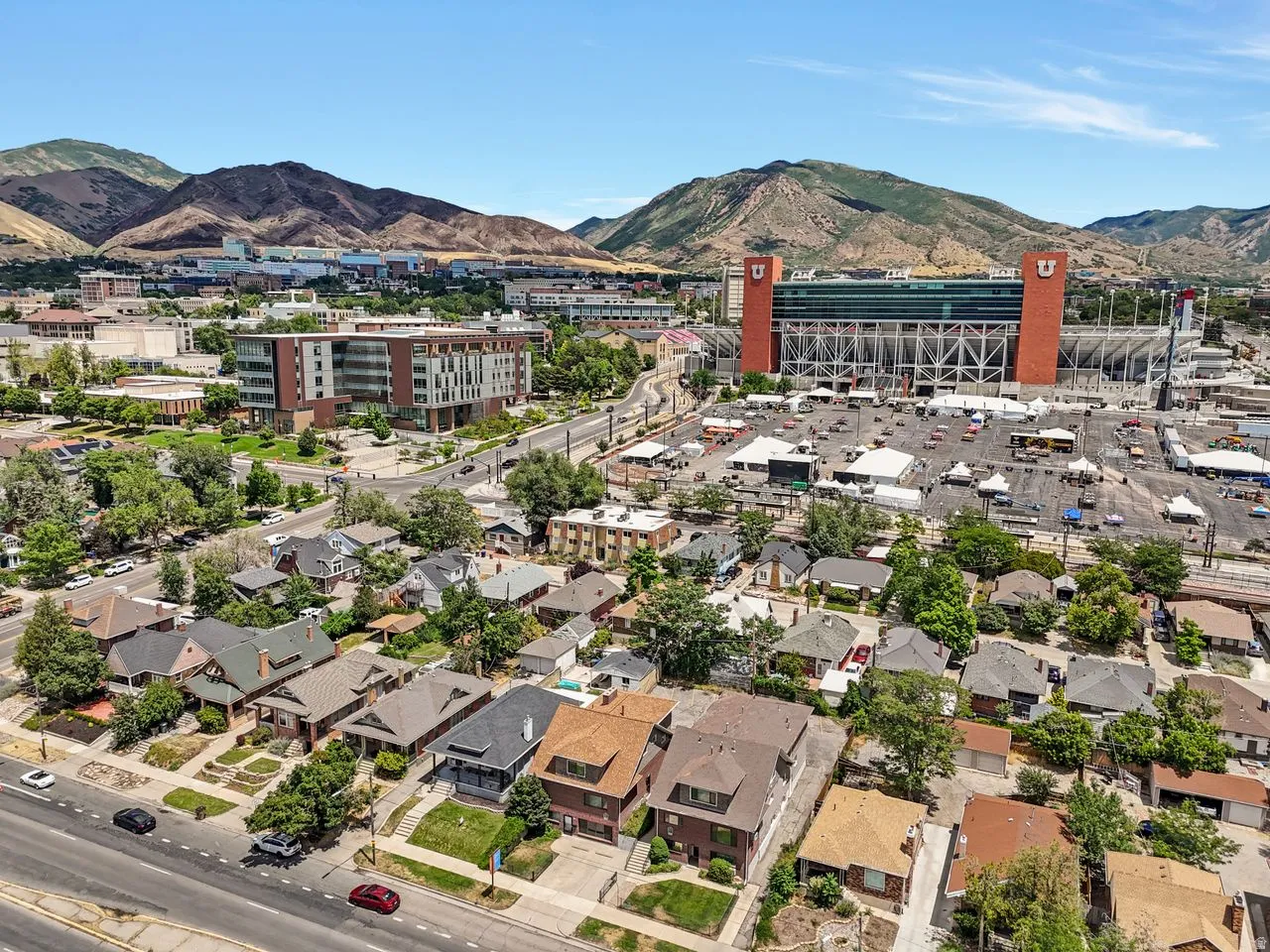 Aerial perspective showcasing a dense urban neighborhood against a backdrop of distant mountains