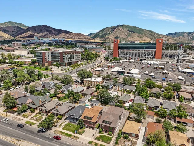 Aerial perspective showcasing a dense urban neighborhood against a backdrop of distant mountains