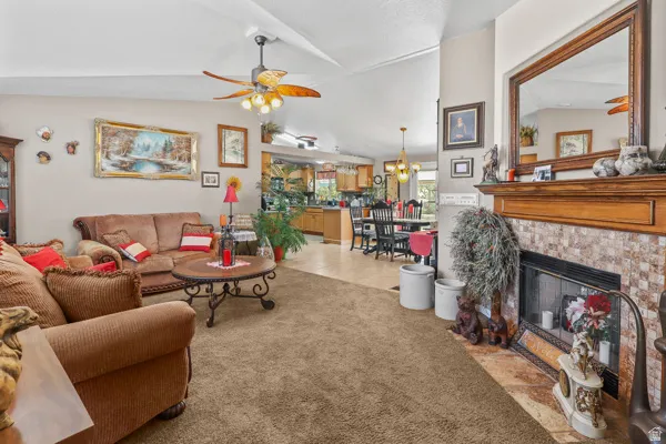 Living area featuring a floor-to-ceiling fireplace with a tile surround and wood mantel