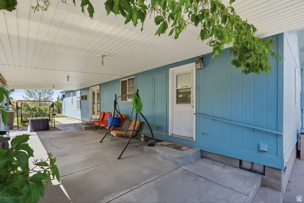 Covered patio featuring a concrete surface, light blue siding, and white soffit ceiling