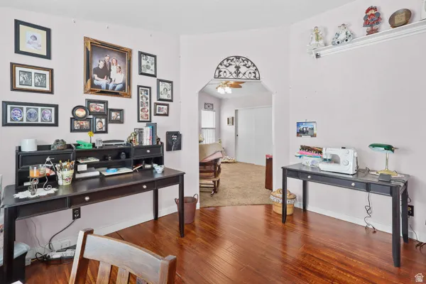 Room featuring rich wood-finish flooring and light-toned walls