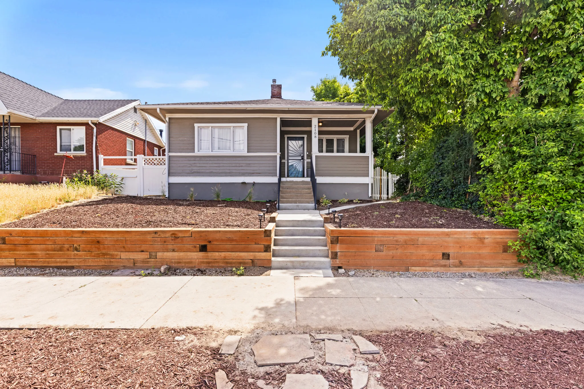 Craftsman-style exterior with a covered porch, concrete steps, and a decorative screen door