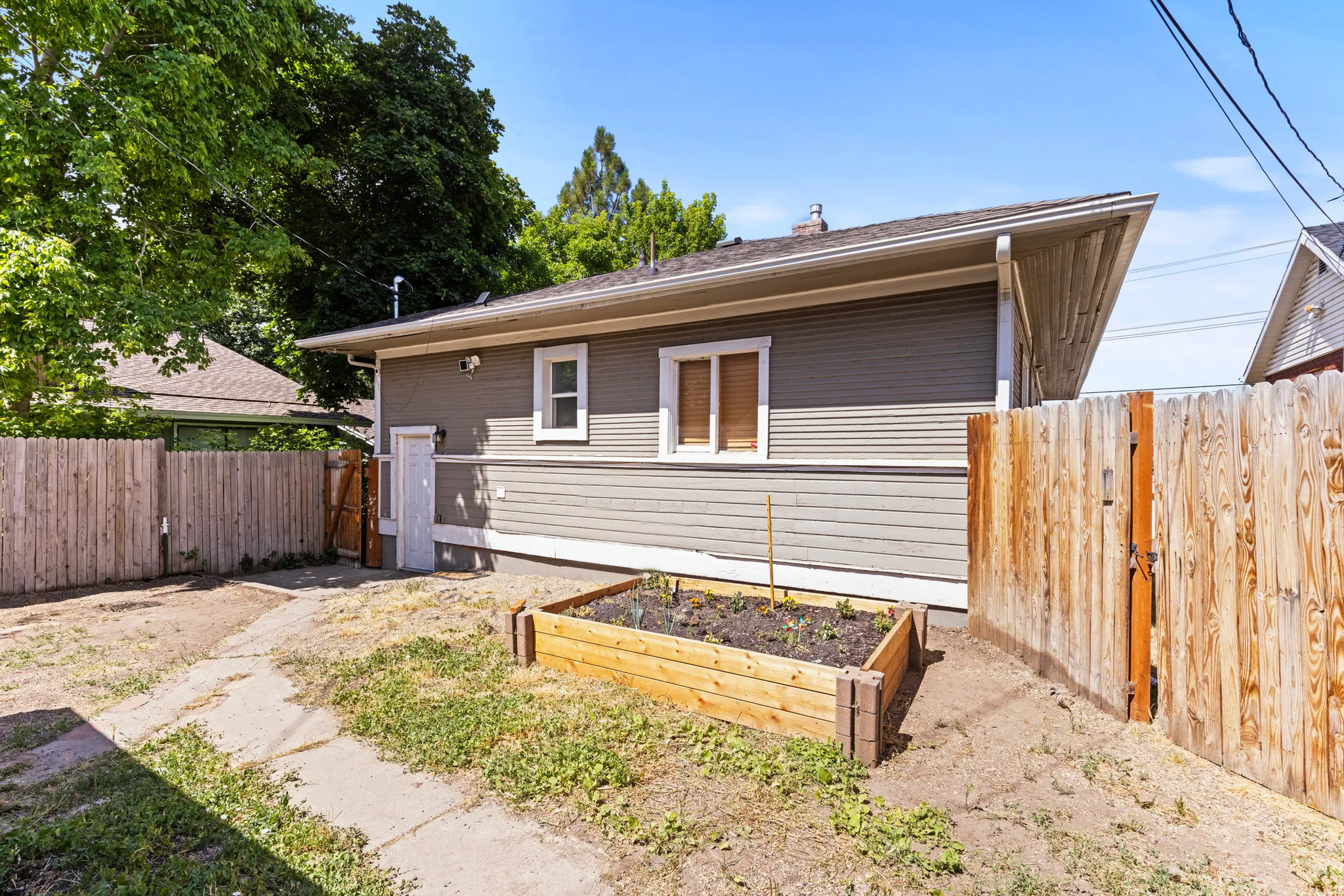 Side exterior of the property featuring horizontal siding and white trim