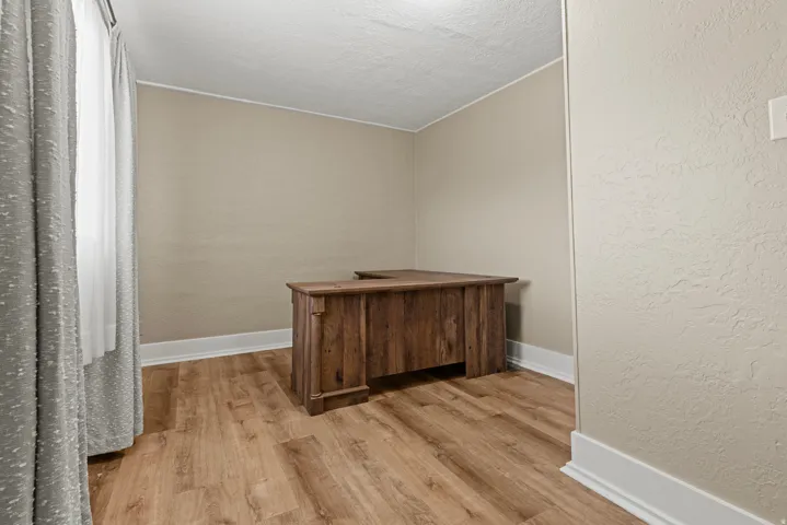 Room featuring wood-finish flooring and neutral wall tones