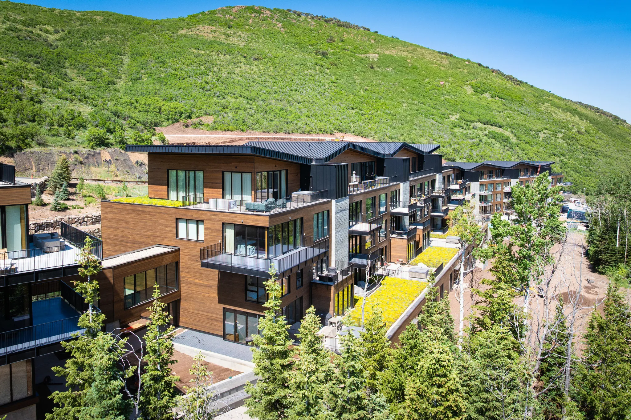 Modern multi-story structure featuring extensive wood paneling and black trim