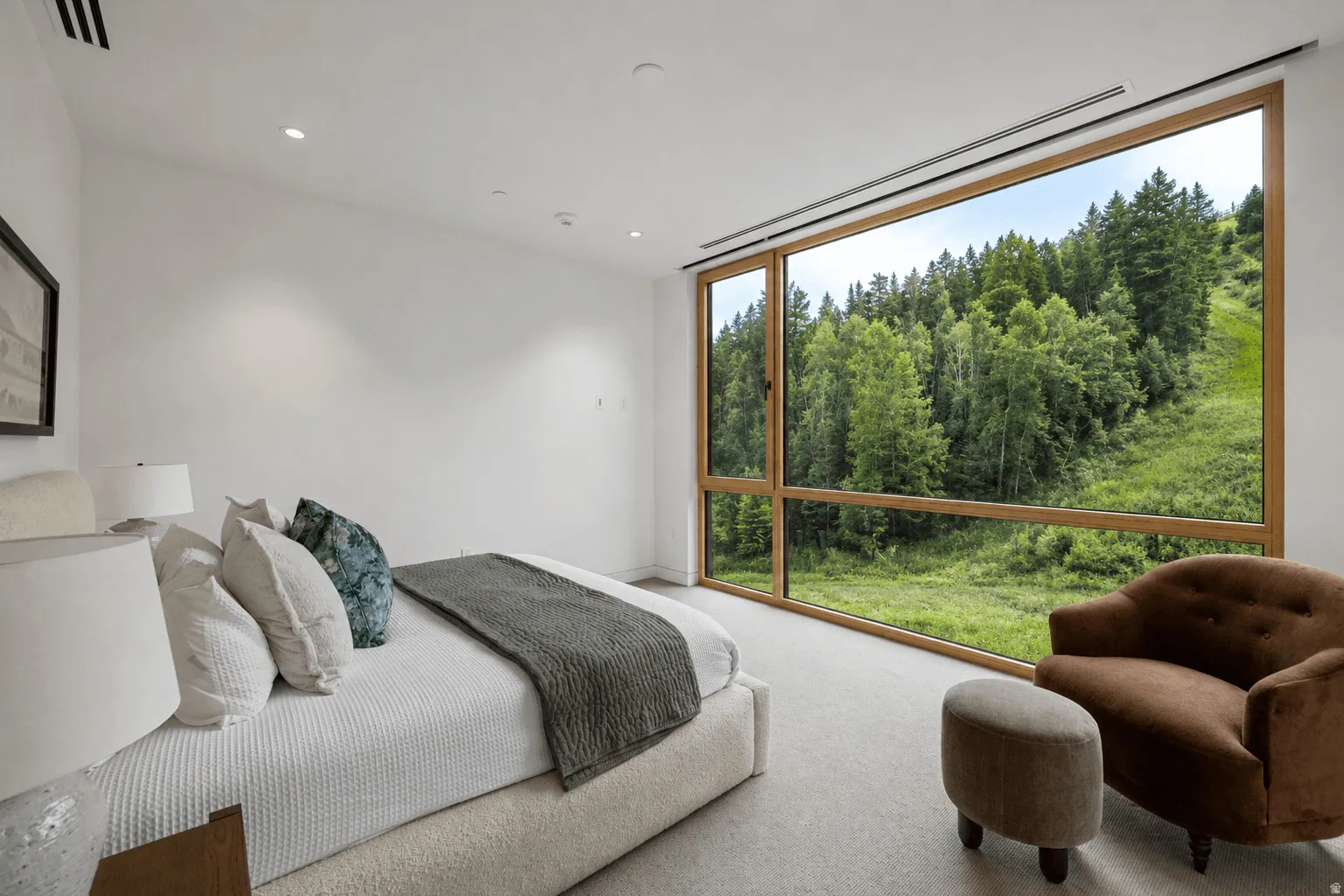 Expansive floor-to-ceiling window system with wood-finish framing