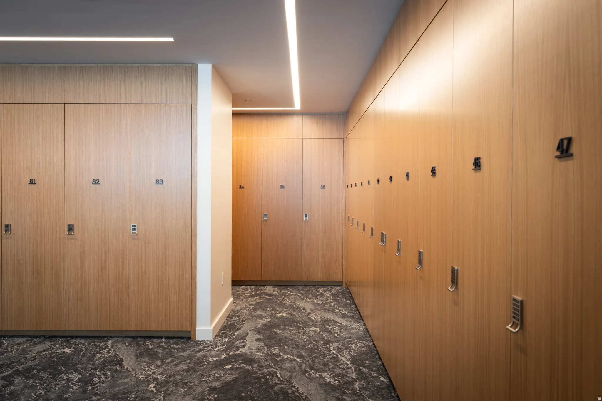 Hallway with extensive wood-finish cabinetry and integrated lighting