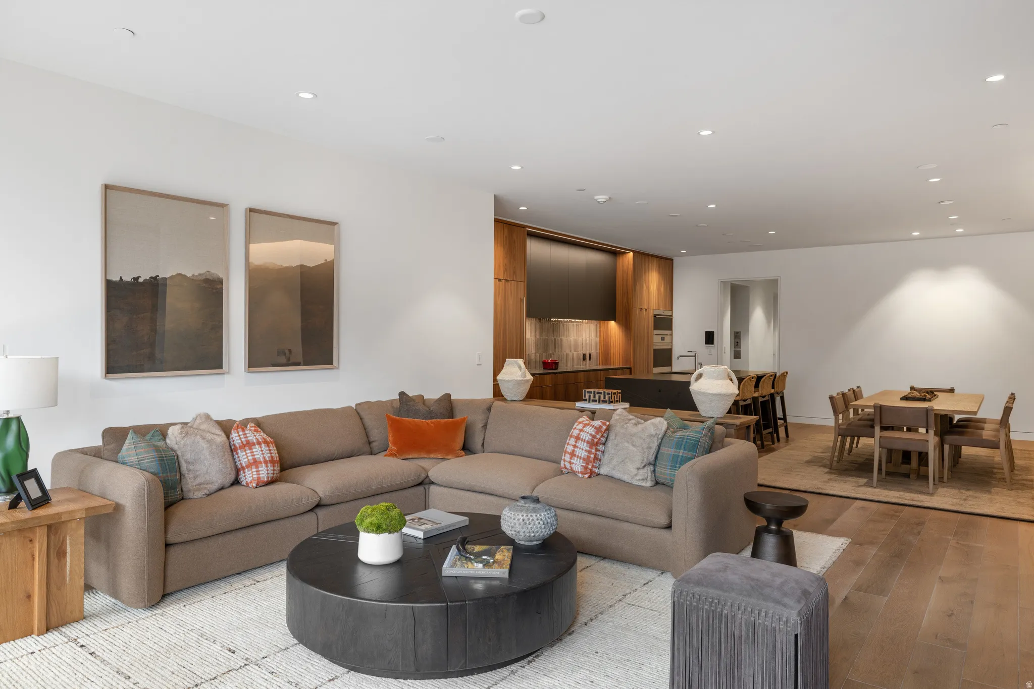 Open-concept living area with light-toned hardwood-style flooring