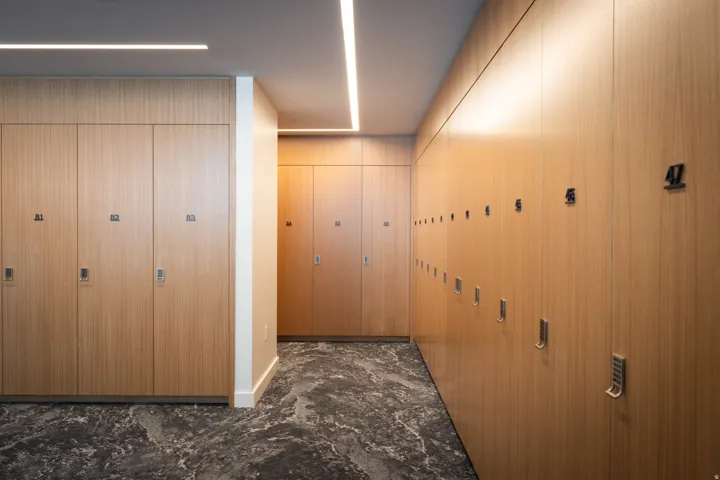 Hallway with extensive wood-finish cabinetry and integrated lighting