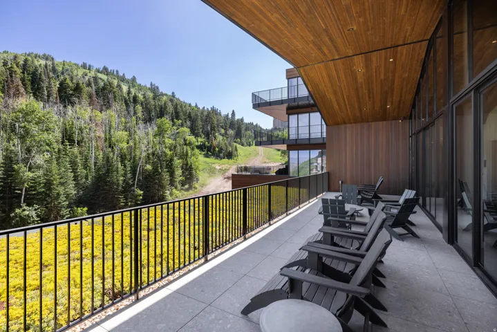 Expansive outdoor patio with a wood-finish ceiling and a black metal railing