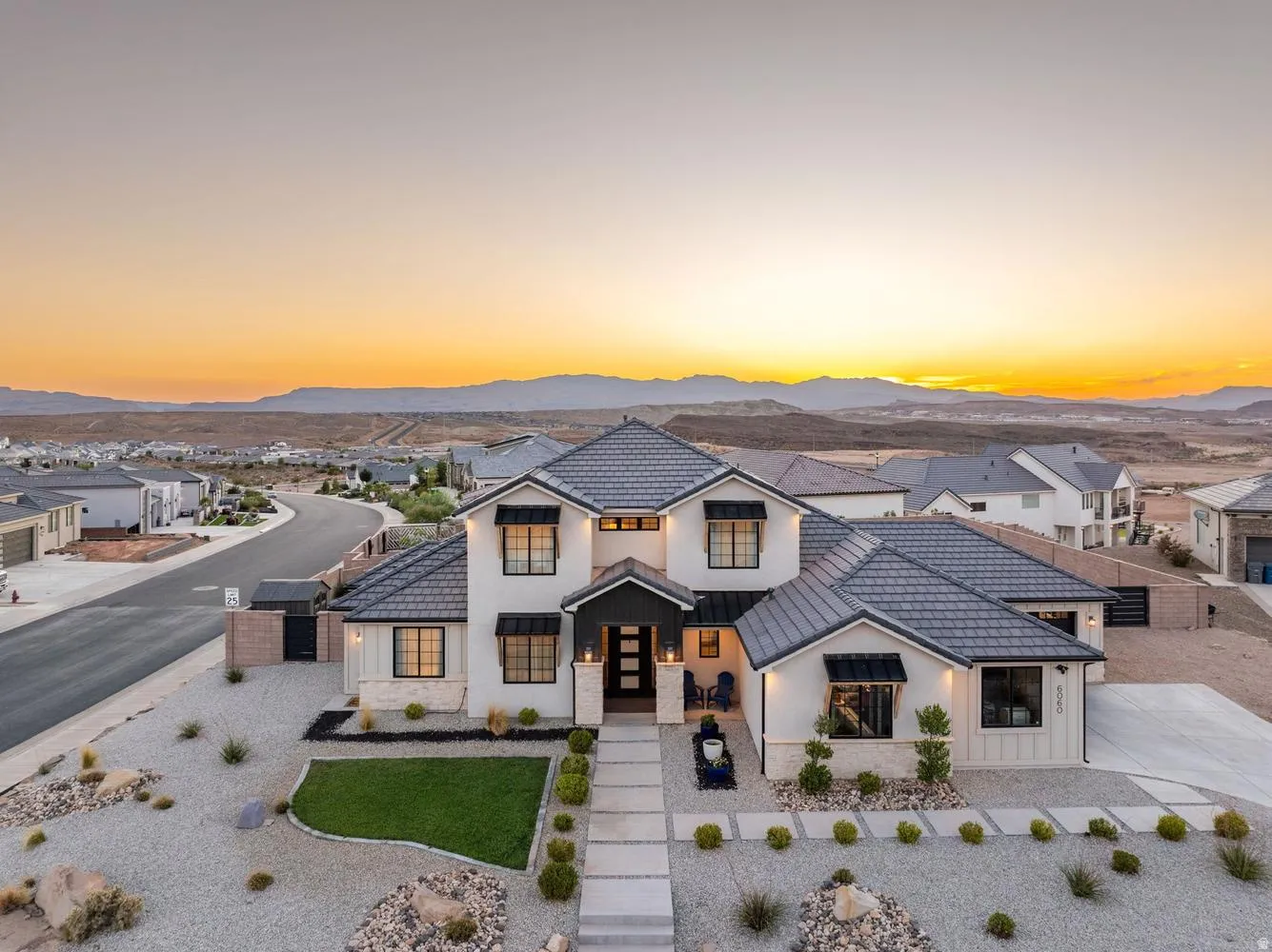 Modern stucco and board and batten exterior with dark tile roofing