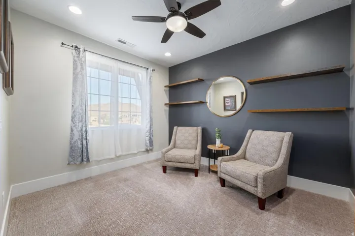 Room featuring recessed lighting, a ceiling fan, a window with exterior mountain scenery, and built-in wood-finish shelving