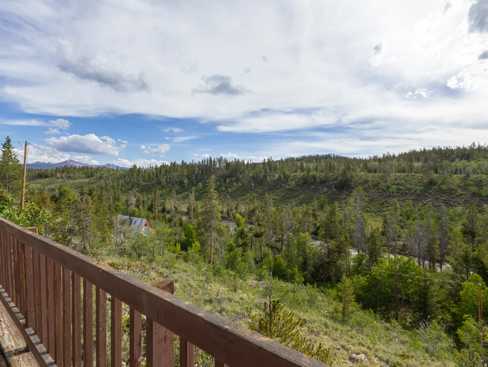 Expansive deck featuring a wood-finish railing