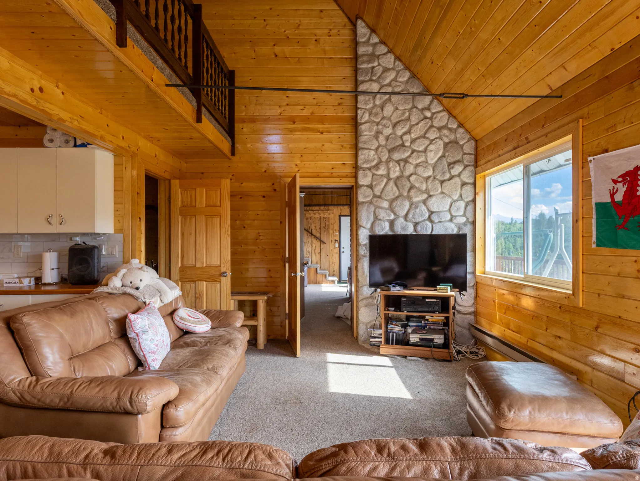 Living space featuring extensive natural wood-finish wall and ceiling panels
