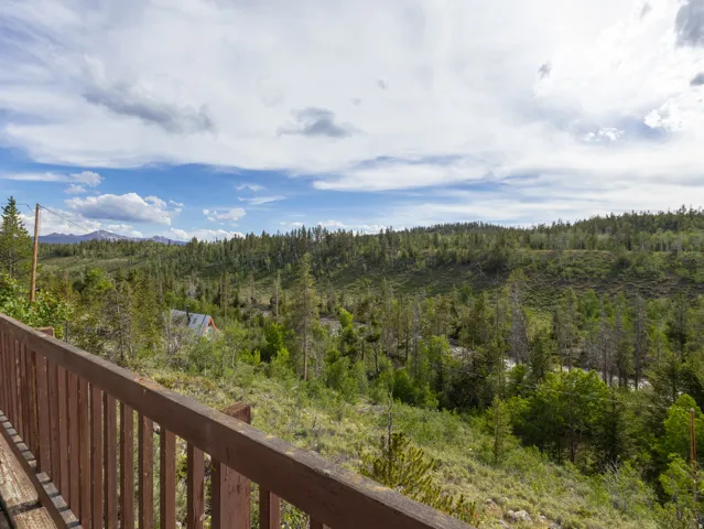 Expansive deck featuring a wood-finish railing