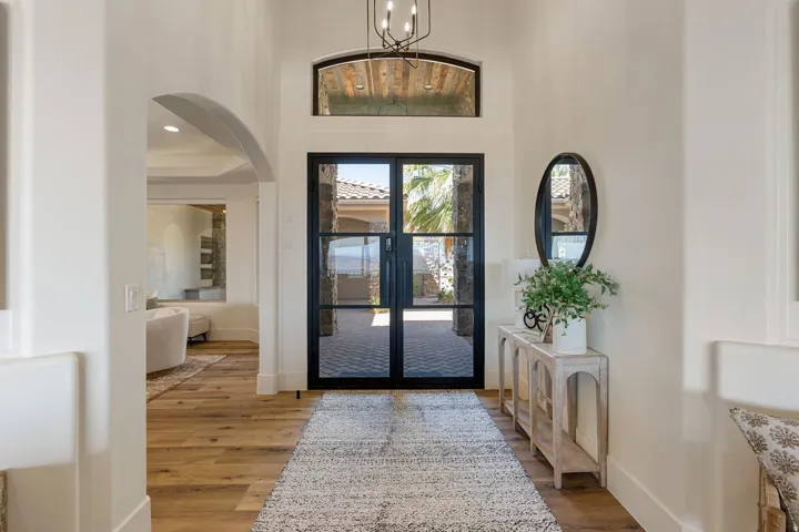 Entryway featuring black-framed double glass doors, a transom window, and wood-finish flooring