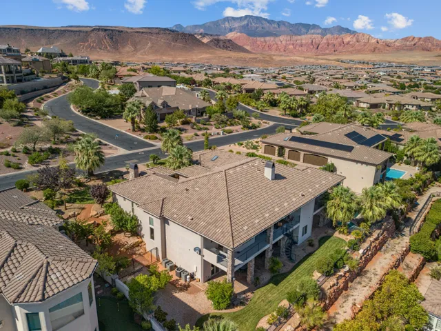 Expansive property featuring a multi-level design, a large tiled roof, and a spiral staircase