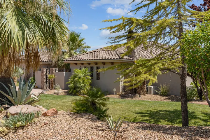 Exterior with a tiled roof, stucco finish, and multiple windows