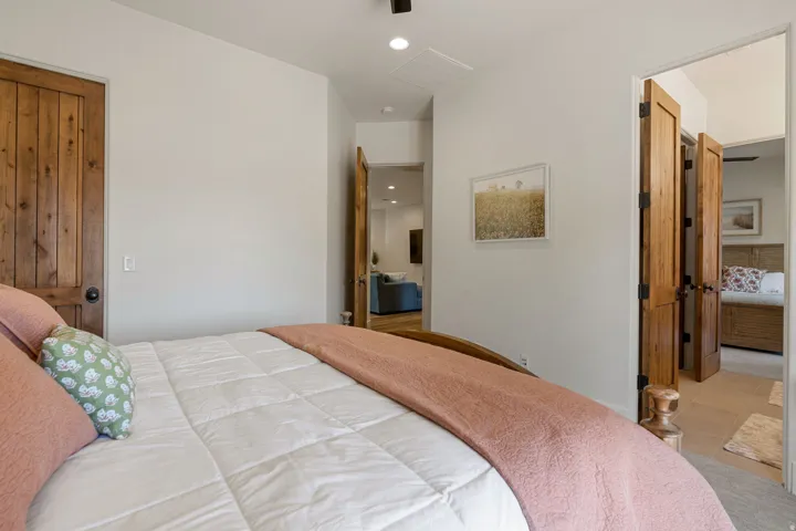 Interior room featuring light-toned walls, wood-finish interior doors, and a ceiling-mounted light fixture