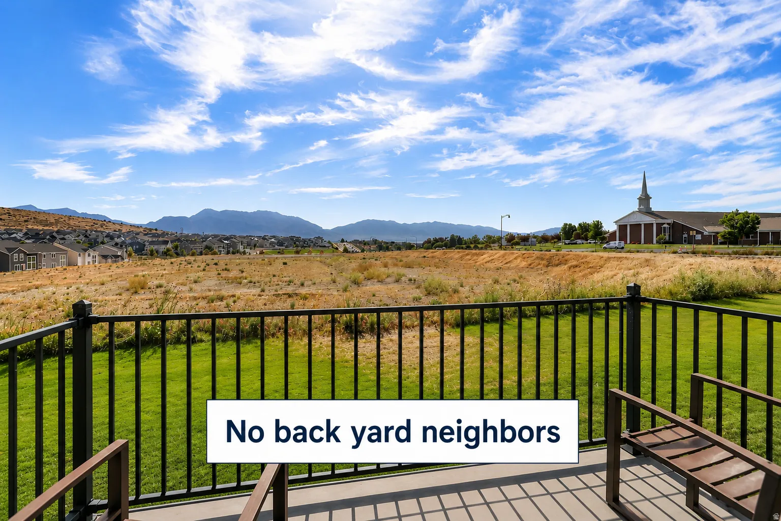 Expansive mountain and landscape scenery from a private outdoor deck with metal railings