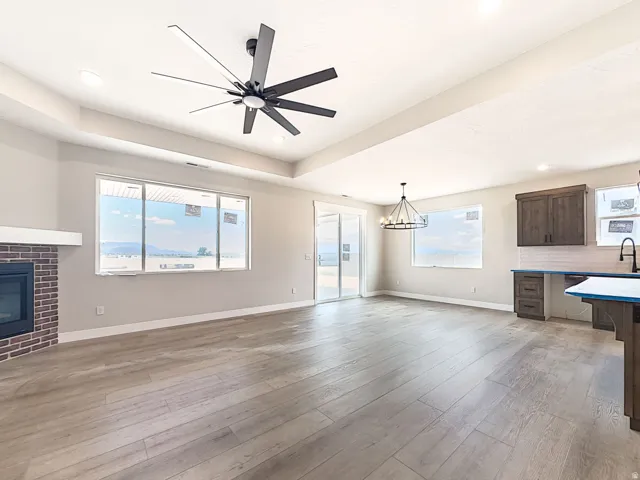 Open-concept room featuring wood-finish flooring, a contemporary ceiling fan, and recessed lighting