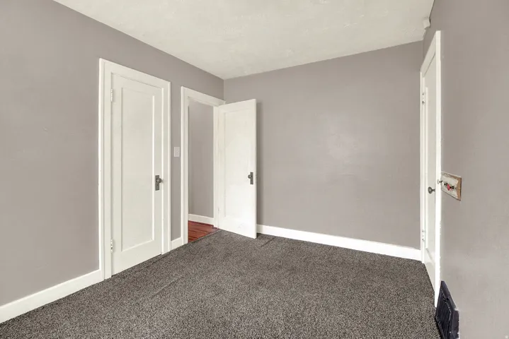 Room featuring neutral gray walls and white trim